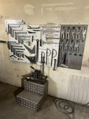 many tools hanging on the wall in the garage