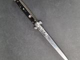 a close up of a knife laying on top of a table