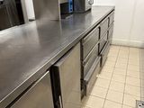 a kitchen with stainless steel counter tops and stainless steel cabinets