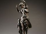 bronze statue of a woman on a horse with a bird in her hand