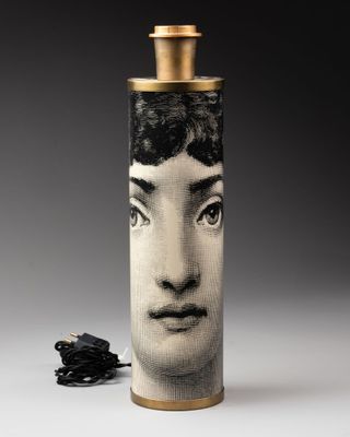 a picture of a lamp with a picture of a woman ' s face on it