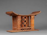 a wooden sculpture of a birdhouse with a bird on top of it