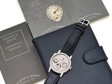 a close up of a watch and a book on a table