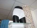 a display of underwear on a shelf in a bathroom