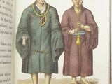 two men standing next to each other in front of an open book