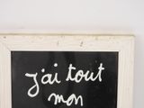 blackboard with white writing that says jai tout men on it