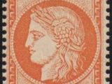an orange and black stamp with a woman ' s head on it