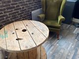 two chairs and a table in a room with a brick wall