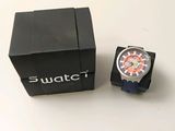 a watch sitting next to a black box on a table