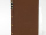 a brown book sitting on top of a white table
