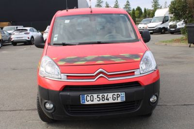 a small red van parked in a parking lot