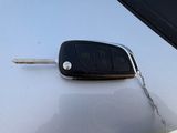 a car key on the hood of a white car