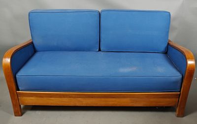 an image of a blue couch with a wooden frame and blue cushions