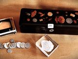 a small box with coins and a small box with a picture on it