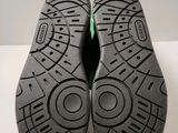 the soles of a pair of black shoes on a white surface
