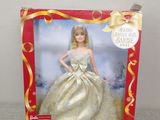 the barbie doll is in a red box with a gold dress