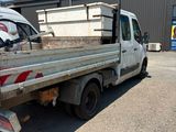 a white truck with a flat bed parked in front of a building