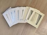 several envelopes of different sizes and colors on a wooden table