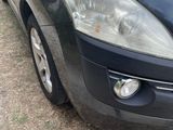 a black car that is parked on the side of the road
