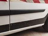a white van with a red stripe painted on the side of it