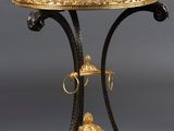 a gold and black table with a lion head on it