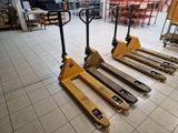 several pallets are lined up on the floor in a warehouse