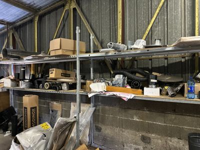 a man standing in a room with a lot of boxes