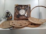 a clock that is sitting on a shelf next to some baskets