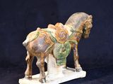 a statue of a horse with a saddle on it ' s back