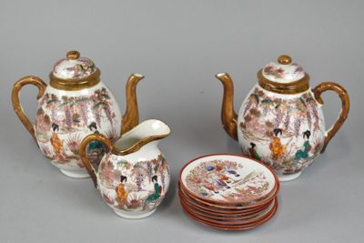 three pieces of porcelain teapots and a plate on the table