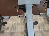 a stationary exercise bike in a gym room with other equipment