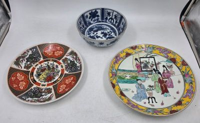 three plates with asian designs on them are sitting on a table