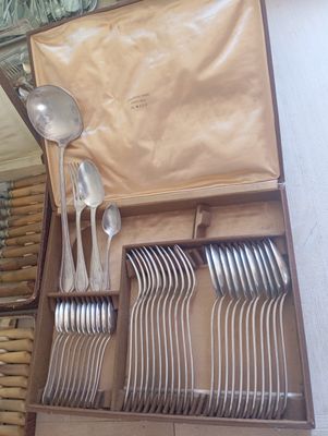 a lot of spoons and forks in a box