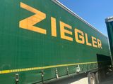 a green semi truck with a yellow ziegler logo on the side