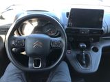 a picture of a person sitting in a car with their feet on the steering wheel