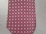 a close up of a red neck tie with a pattern on it