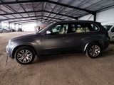 a picture of a bmw suv parked in a garage