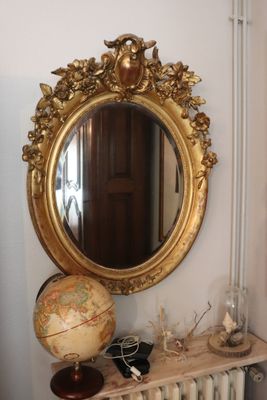 a mirror on the wall above a radiator in a room