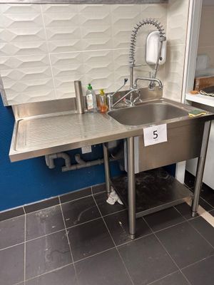 une cuisine équipée d'un évier et d'un lave-vaisselle