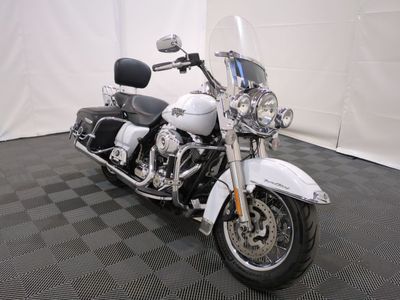 a white motorcycle that is parked on a black and white checkered floor
