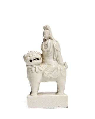 a statue of a woman sitting on a dog