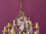 an image of a chandelier hanging from the ceiling in a purple room
