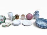 many plates and bowls and vases on the table