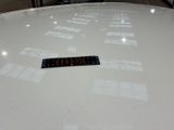 a sticker on the top of a car that is sitting in a showroom