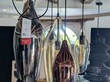 a room with a bunch of lamps hanging from the ceiling