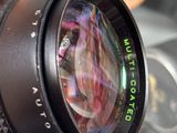 a person holding a camera lens in their hand