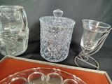 a glass tray with a glass candle holder and a glass vase