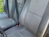 two seats in the back of a car with a steering wheel