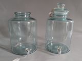 two glass jars that are sitting on a table