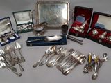 silverware and silverware on a table with other silverware
